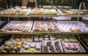 A large variety of donuts and pastries in a glass case | Puerto Penasco Brunch